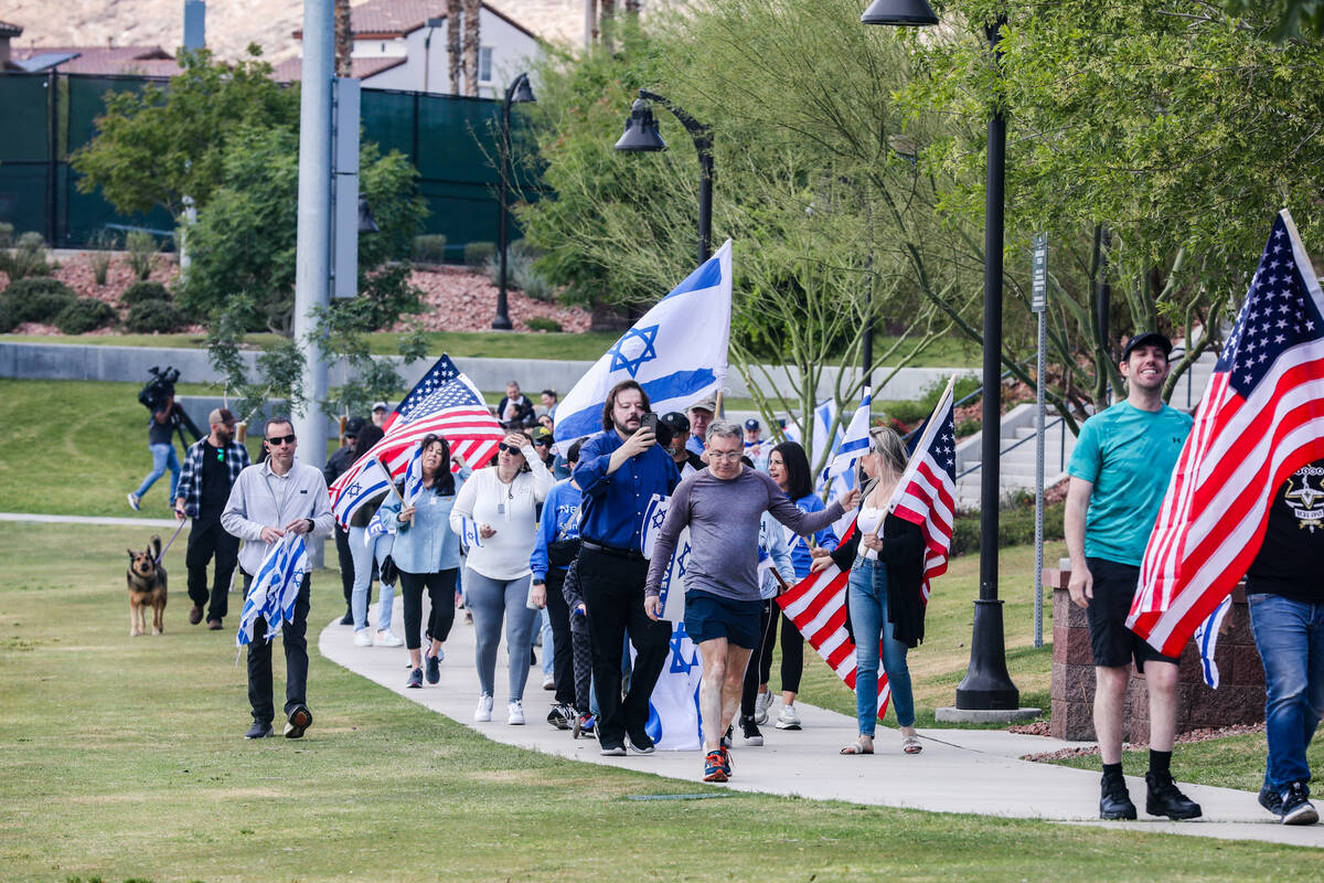 Participants march through Sagemont Park during a rally hosted by the Las Vegas chapter of the ...