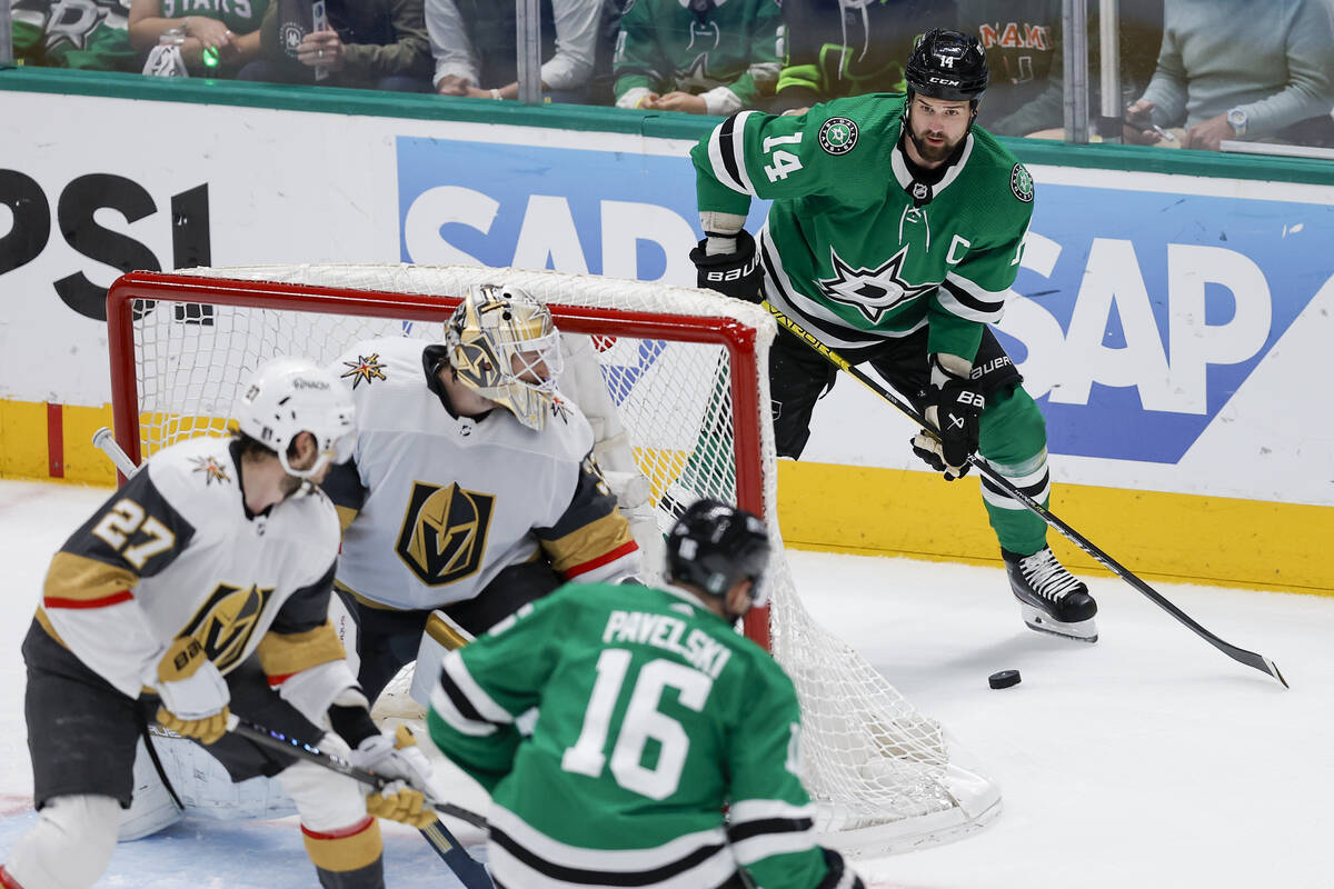 Dallas Stars' Jamie Benn (14) controls the puck as he and teammate Joe Pavelski (16) attack aga ...