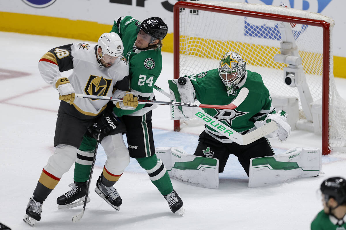 Dallas Stars goaltender Jake Oettinger, right, blocks a shot as teammate Roope Hintz (24) defen ...