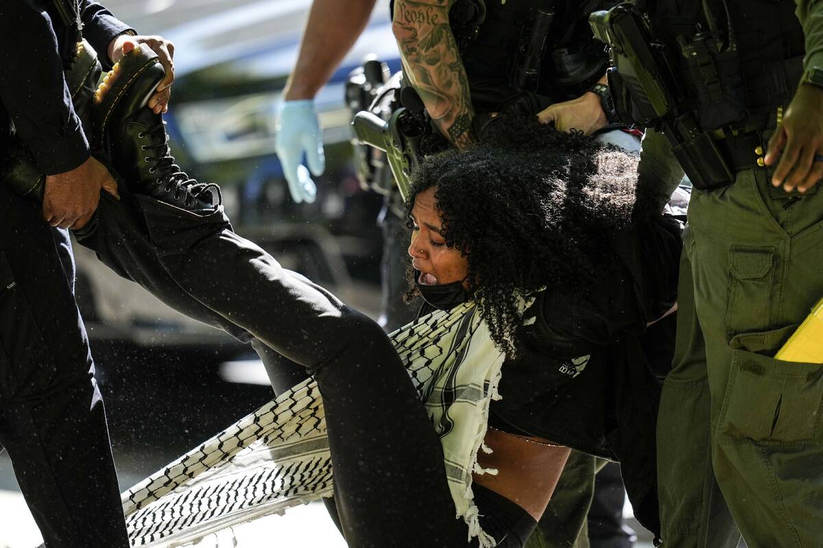 Authorities detain a protester on the campus of Emory University during a pro-Palestinian demon ...