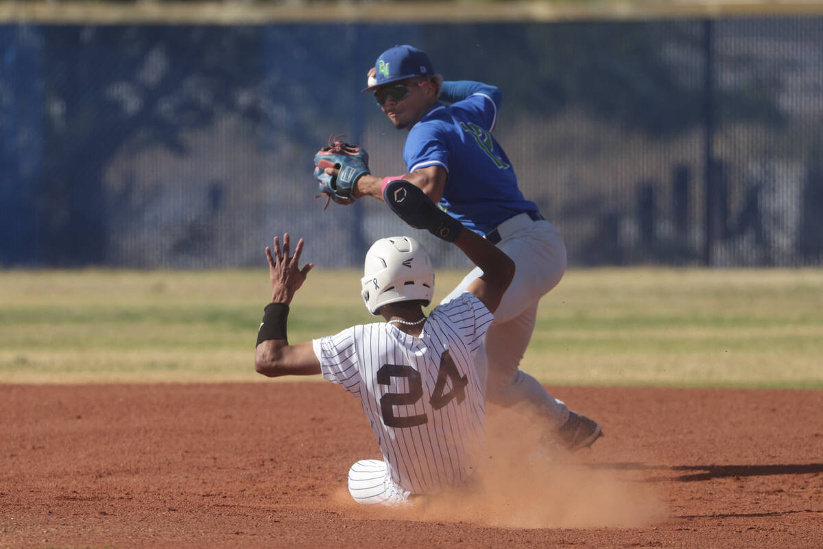 Green Valley's Caden Kirby (12) throws to first base after tagging out Shadow Ridge's Andrew To ...