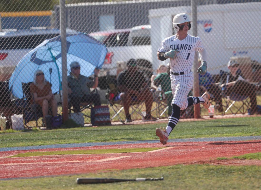 Shadow Ridge's Evan Noble (1) scores a run against Green Valley during a high school NIAA playo ...