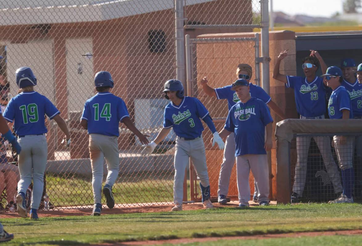 Green Valley players celebrate a run by Benjamin Byington (19) during a high school NIAA playof ...