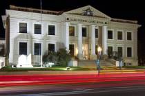 Cars leave trails of light as they pass the Elko County Court House in Elko on Friday, Oct. 19, ...
