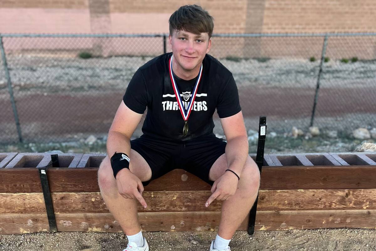 Faith Lutheran senior Preston Beery points to the spot where his state record throw in the shot ...