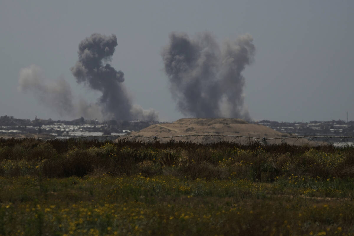 Smoke rises following an Israeli bombardment in the Gaza Strip as seen from southern Israel, Tu ...