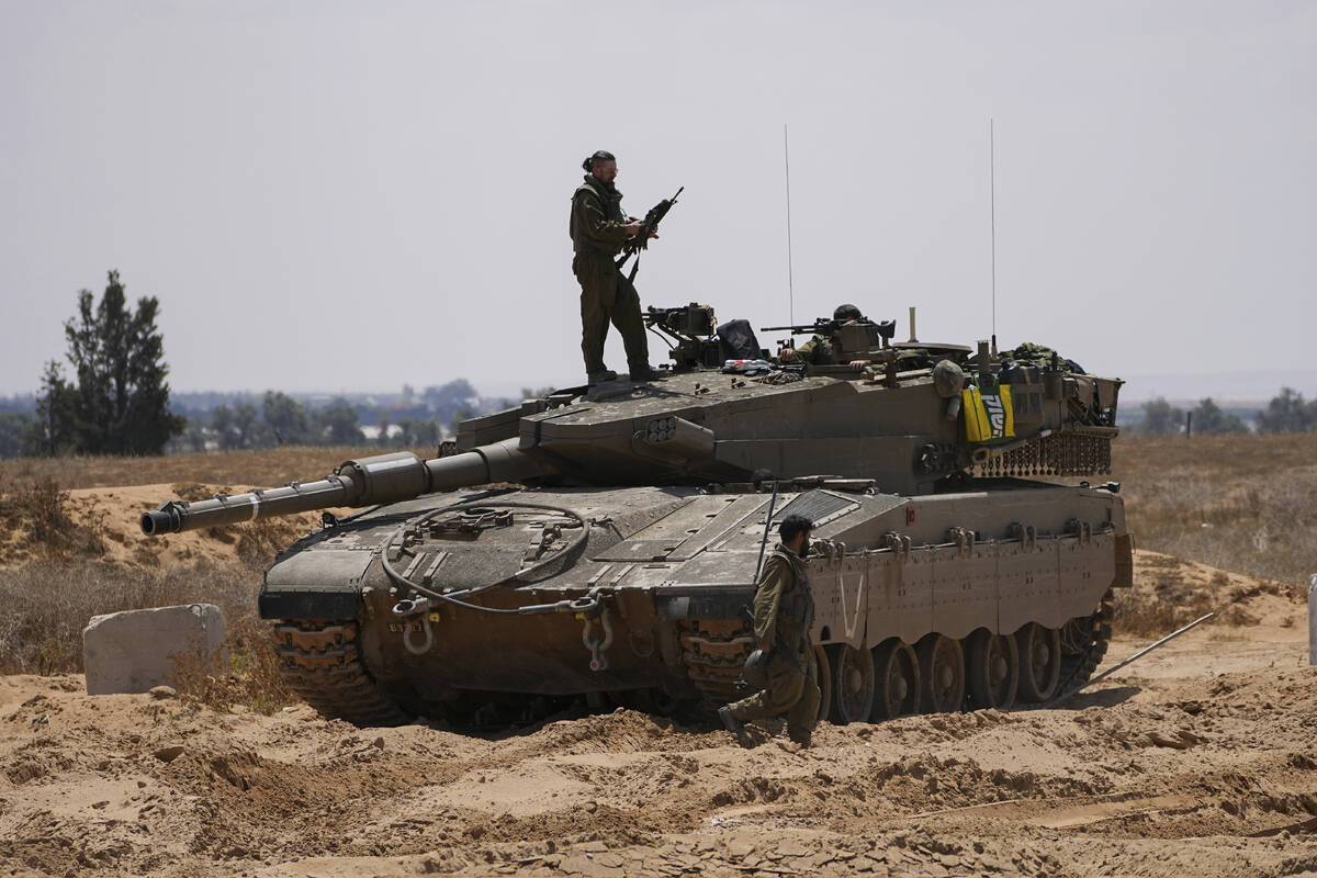 Israeli soldiers are seen near the border with the Gaza Strip, in southern Israel, Tuesday, May ...