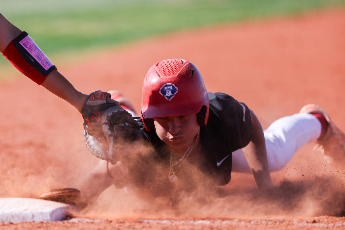 Liberty's Koa Abbott (47) slides safely into first base after attempting to steal second while ...