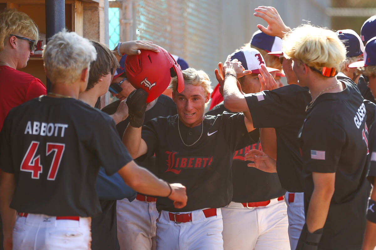 Liberty's Chris Onoszko (1) is congratulated after scoring during a Class 5A high school baseba ...