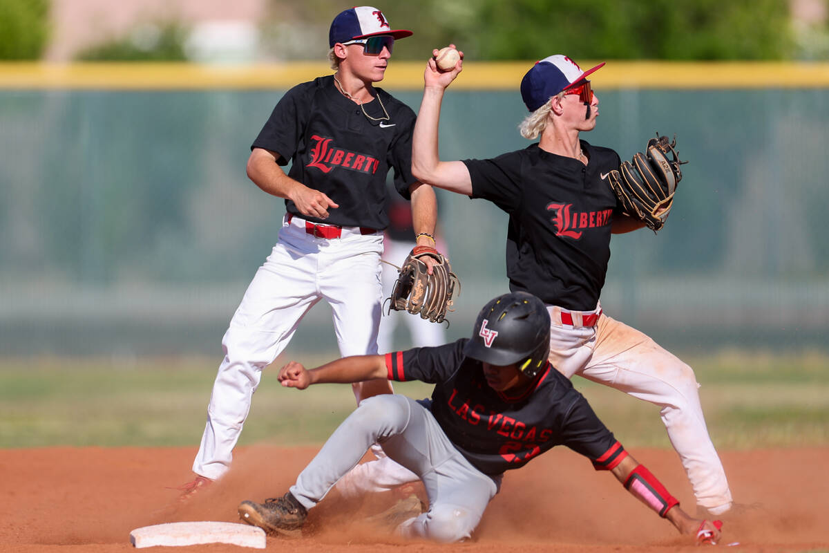 Las Vegas' Aadyn Jaime (23) slides into second base while Liberty's Christopher Hemphill (13) t ...