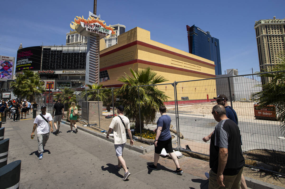People walk by the site of a planned casino-resort, owned by billionaire Tilman Fertitta, on th ...