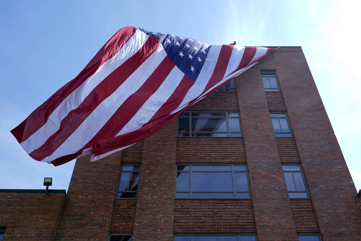 A giant American flag is unfurled on Lisner Hall on the campus of George Washington University ...
