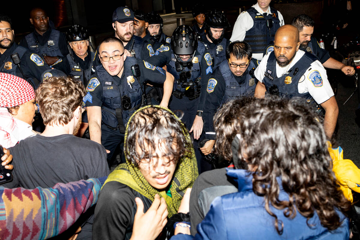 Demonstrators clash with the Metropolitan Police Department officers at George Washington Unive ...