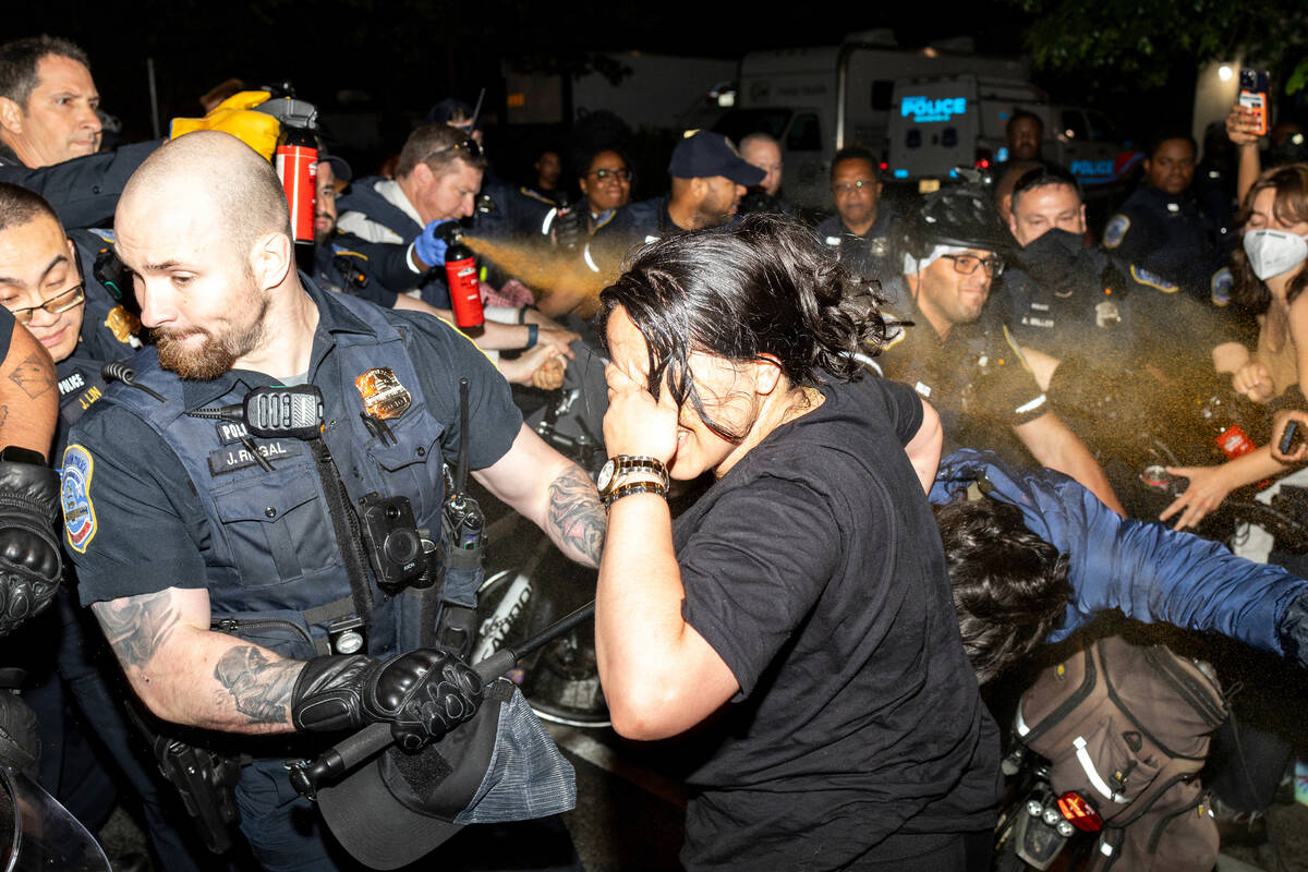 Officers of the Metropolitan Police Department pepper spray demonstrators at George Washington ...