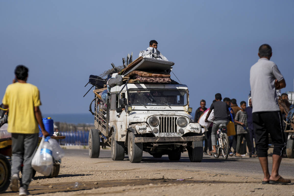 Displaced Palestinians arrive in central Gaza after fleeing from the southern Gaza city of Rafa ...