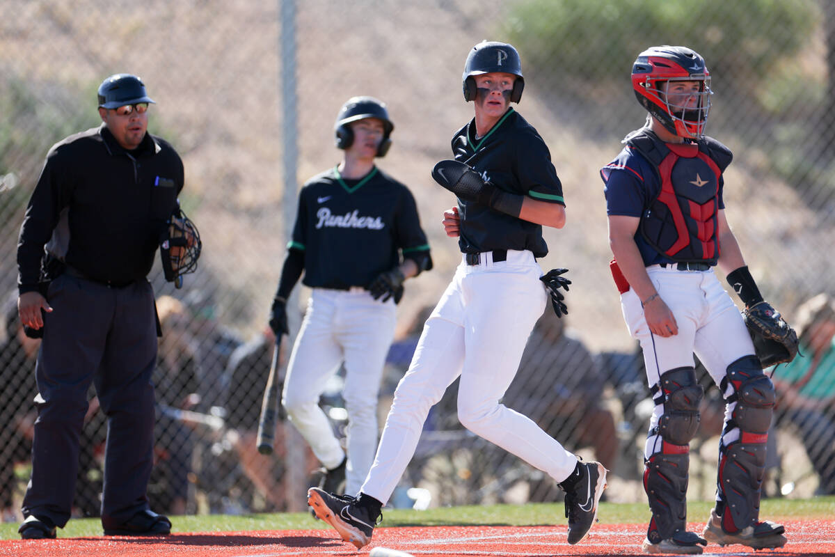 Palo Verde’s Ethan Clauss runs safely into home while Coronado catcher AJ Stalteri looks ...