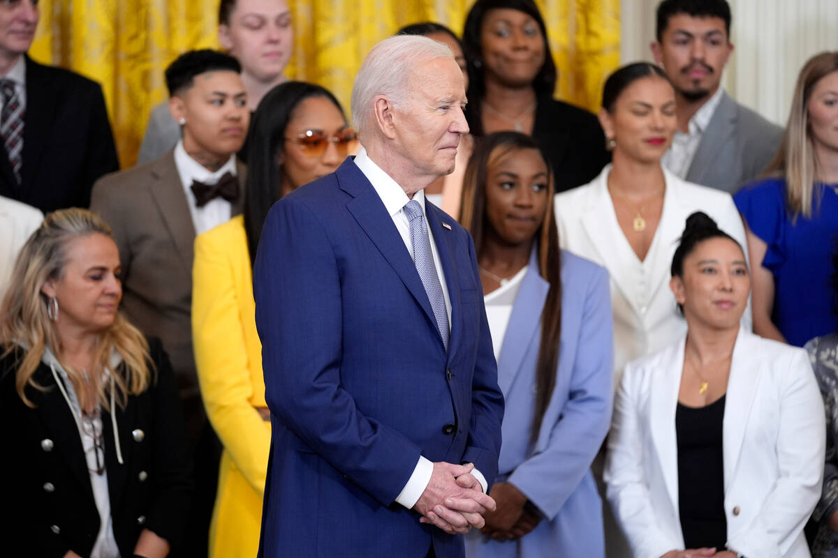 President Joe Biden listens as Vice President Kamala Harris, not pictured, speaks at an event t ...