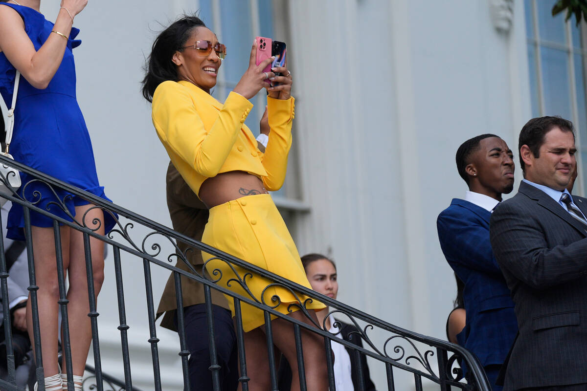 A'ja Wilson, of the 2023 WNBA champion Las Vegas Aces, watches as President Joe Biden takes off ...