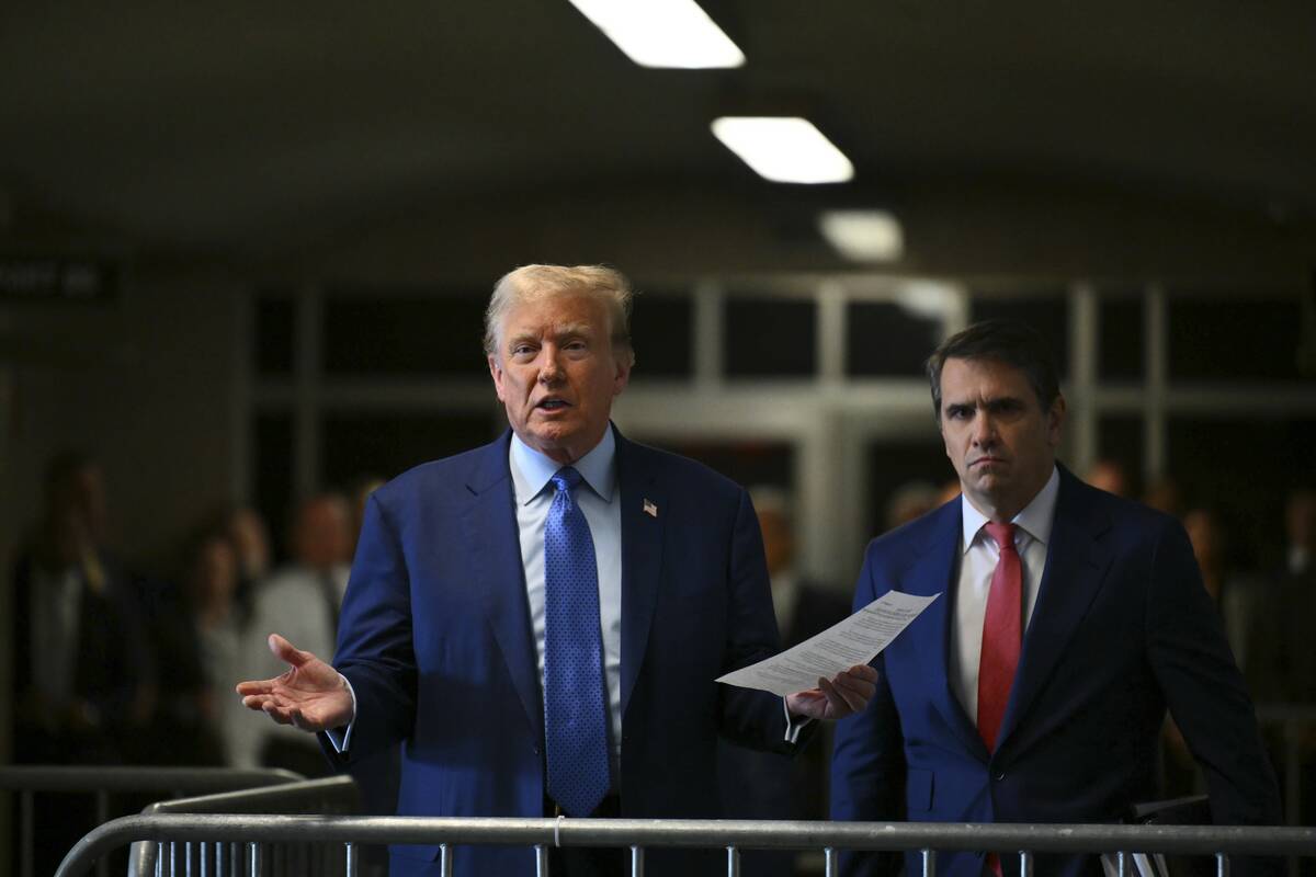 Former President Donald Trump, with lawyer Todd Blanche, speaks to reporters at Manhattan Crimi ...