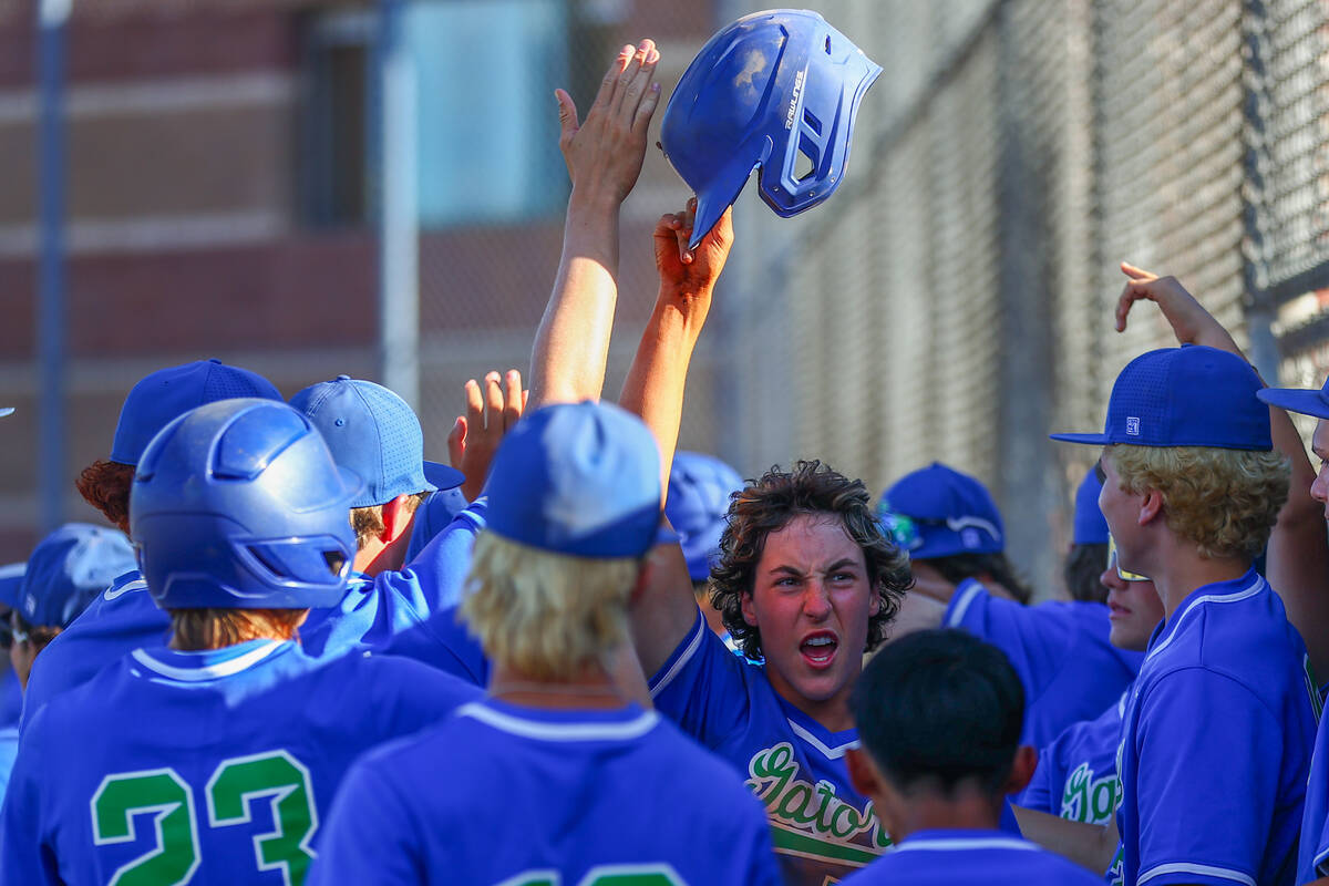 Green Valley congratulates their Jet McNelis, center right, after he scored during a Class 5A h ...