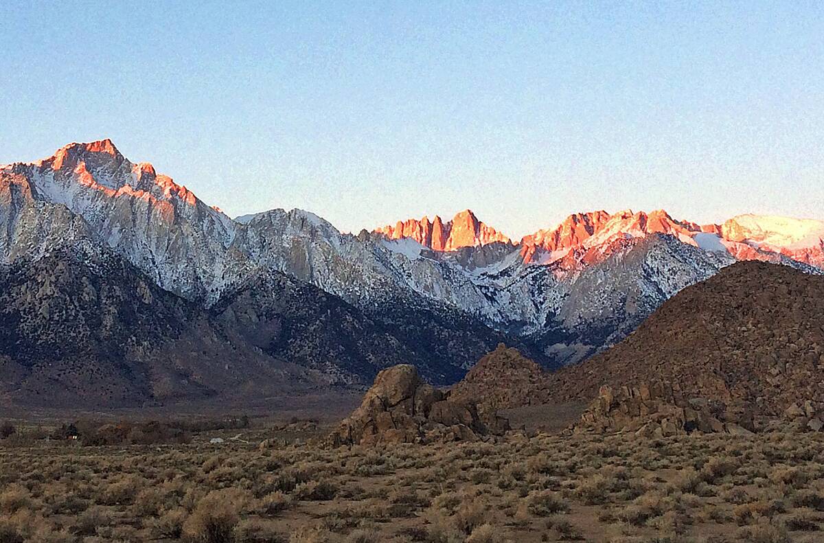 Seen is the eastern Sierra Nevada, with Mt. Whitney, the largest of three pinnacles at center, ...