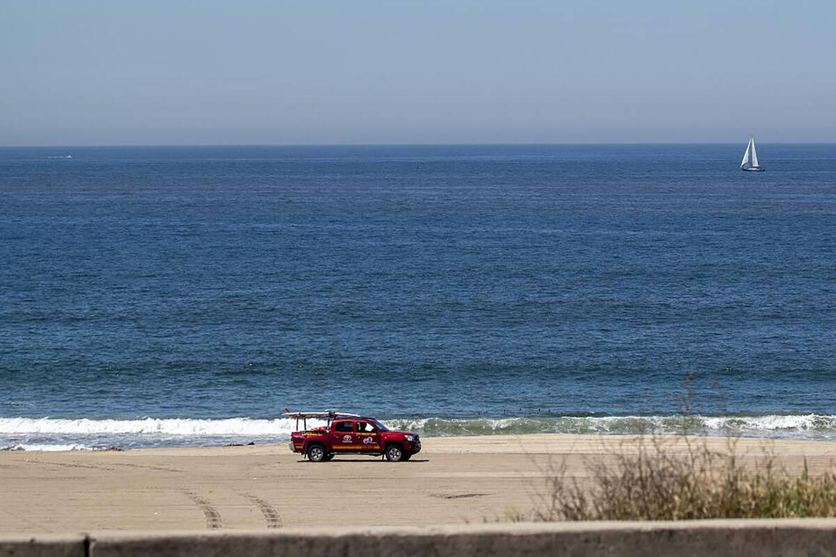 A Los Angeles County lifeguard patrols the closed Playa Del Rey Beach amid coronavirus pandemic ...