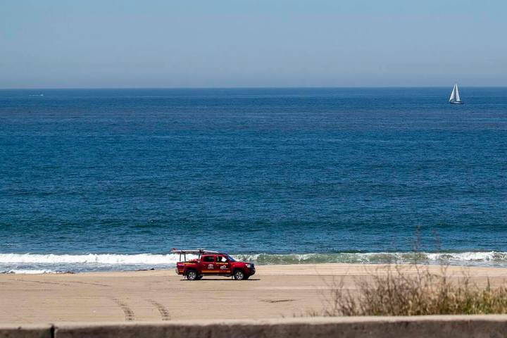 A Los Angeles County lifeguard patrols the closed Playa Del Rey Beach amid coronavirus pandemic ...