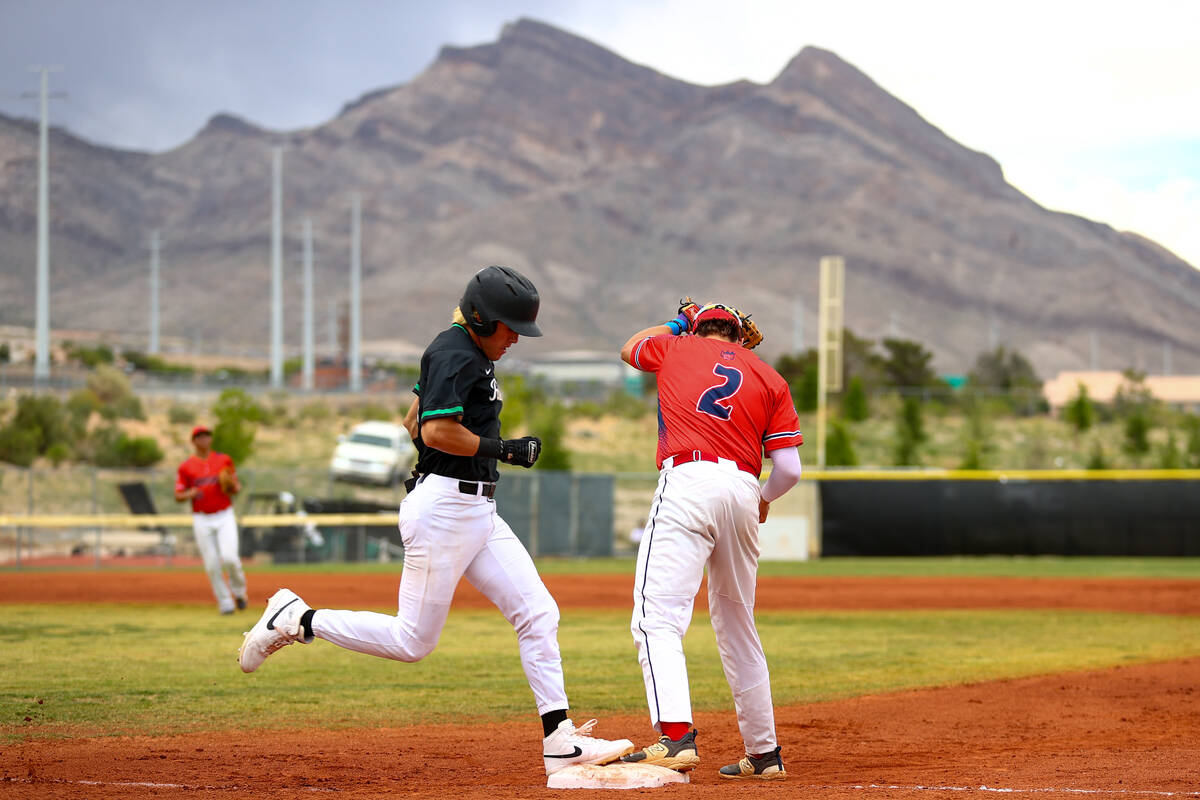 Palo Verde infielder Luke Herrera, left, arrives safely to first base while Coronado first base ...