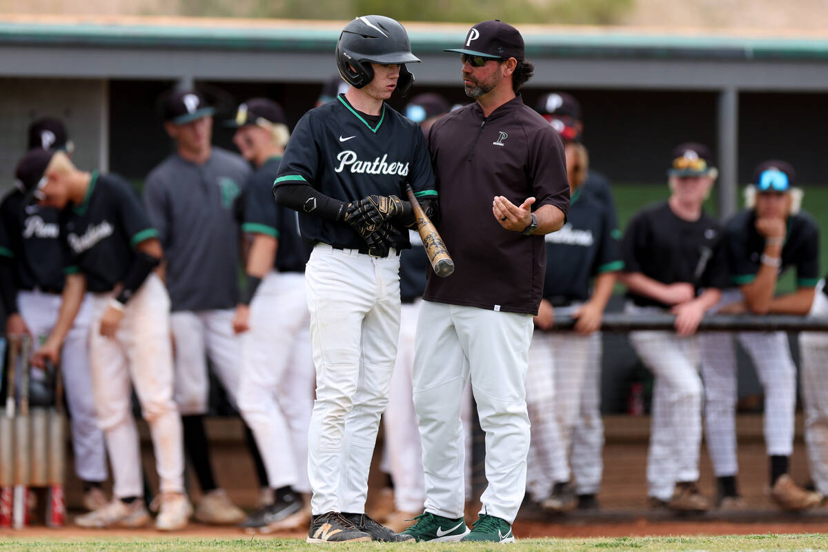 Palo Verde head coach Dustin Romero, right, advises batter Connor Rosinski during a Class 5A hi ...