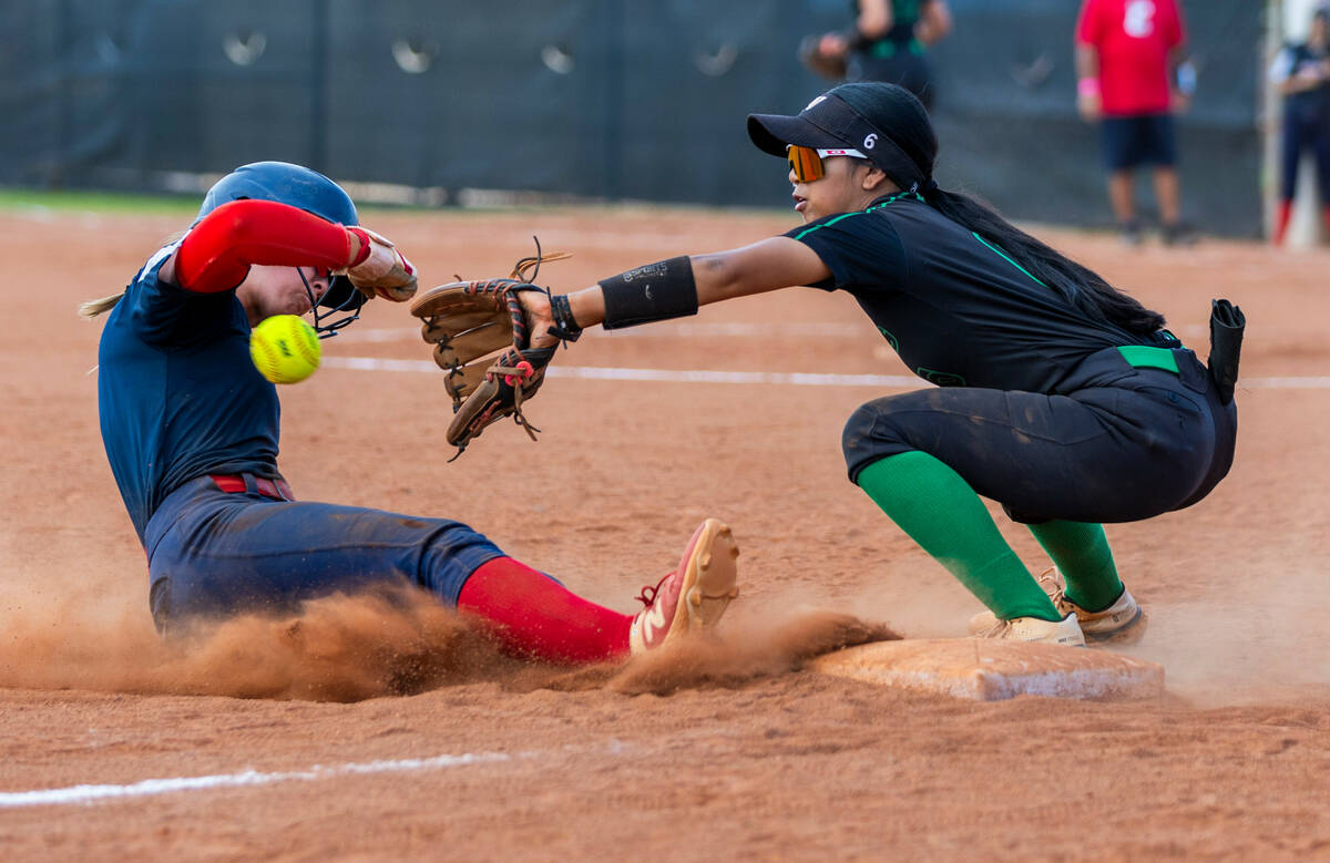 Coronado runner Bailey Goldberg (1) slides to third base safely ahead of a throw to Palo Verde ...