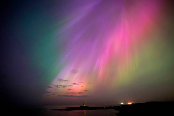 The aurora borealis on the horizon Friday, May 10, 2024, at St. Mary's Lighthouse in Whitley Ba ...