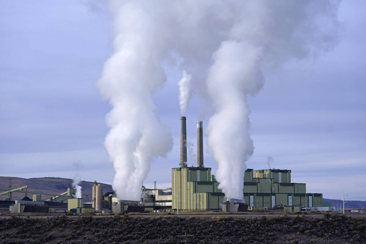 Steam billows from a coal-fired power plant Nov. 18, 2021, in Craig, Colo. (AP Photo/Rick Bowme ...