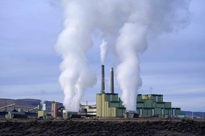 Steam billows from a coal-fired power plant Nov. 18, 2021, in Craig, Colo. (AP Photo/Rick Bowme ...