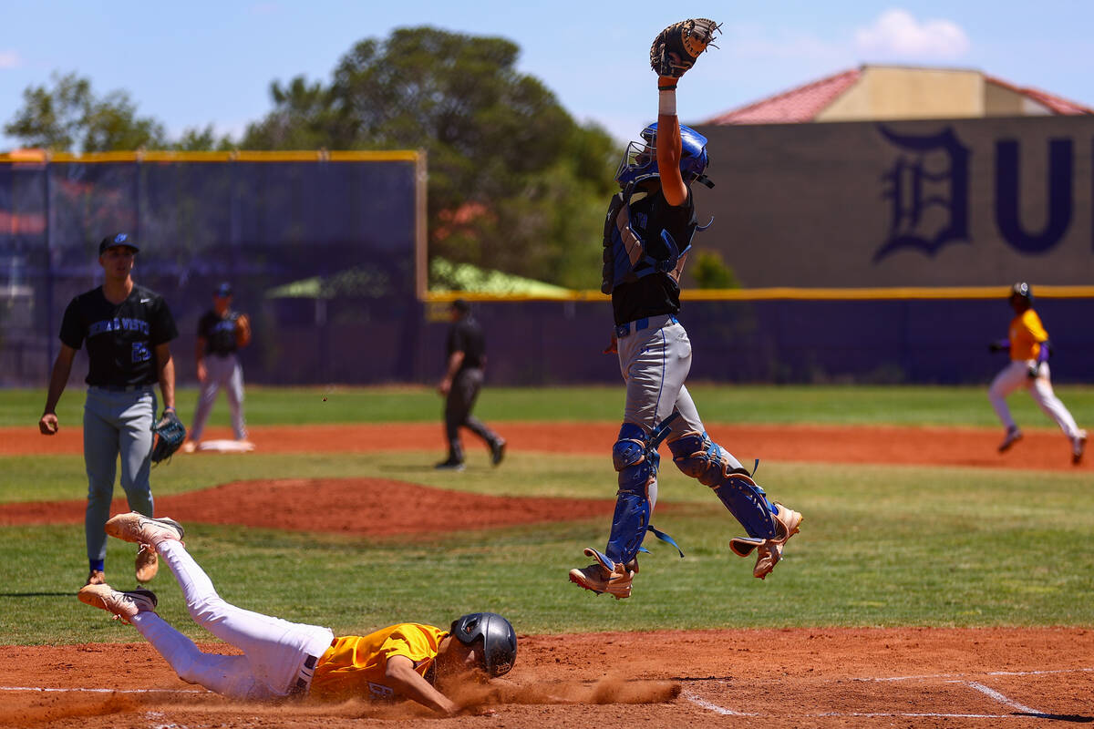 Sierra Vista catcher Dallas Smith (17) jumps to catch while Durango’s Jaylen Bosque (26) ...