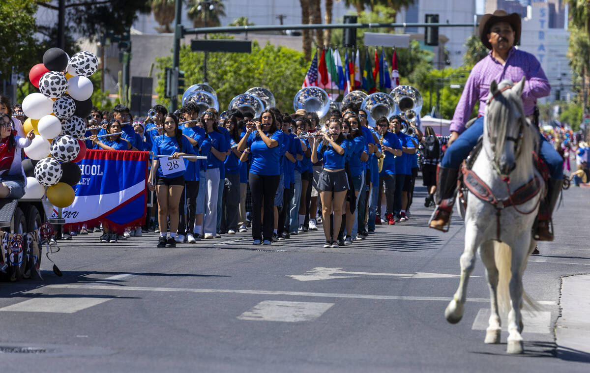 The Valley High School band members perform along the route during the Helldorado Parade moving ...
