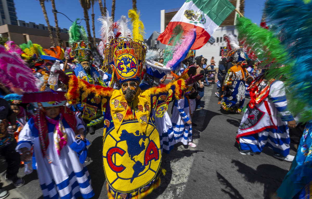 Members of the Banda de Tlayacapan dance and entertain the crowd along the route during the Hel ...