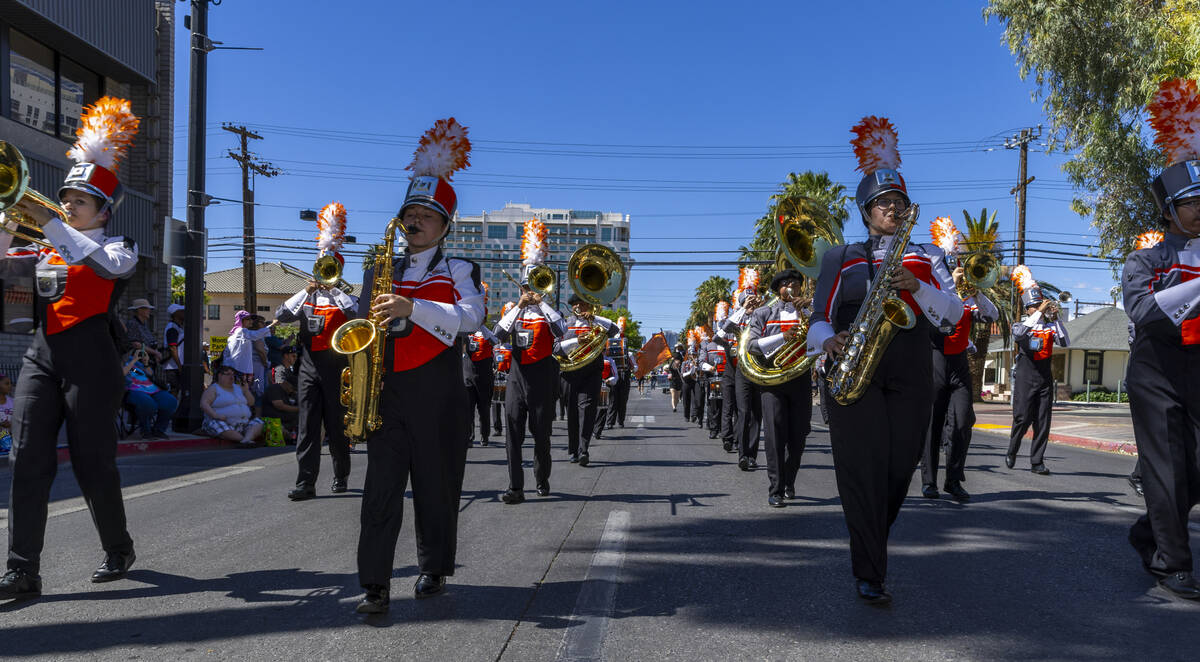 Members of the Chaparral High School marching band perform along the route during the Helldorad ...