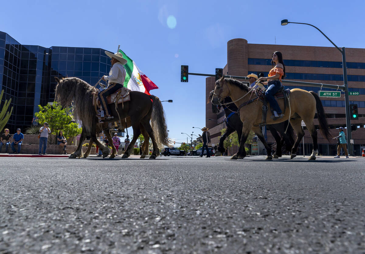 Members of the Escaramuza Charra of Nevada make their way on horseback along the route during t ...