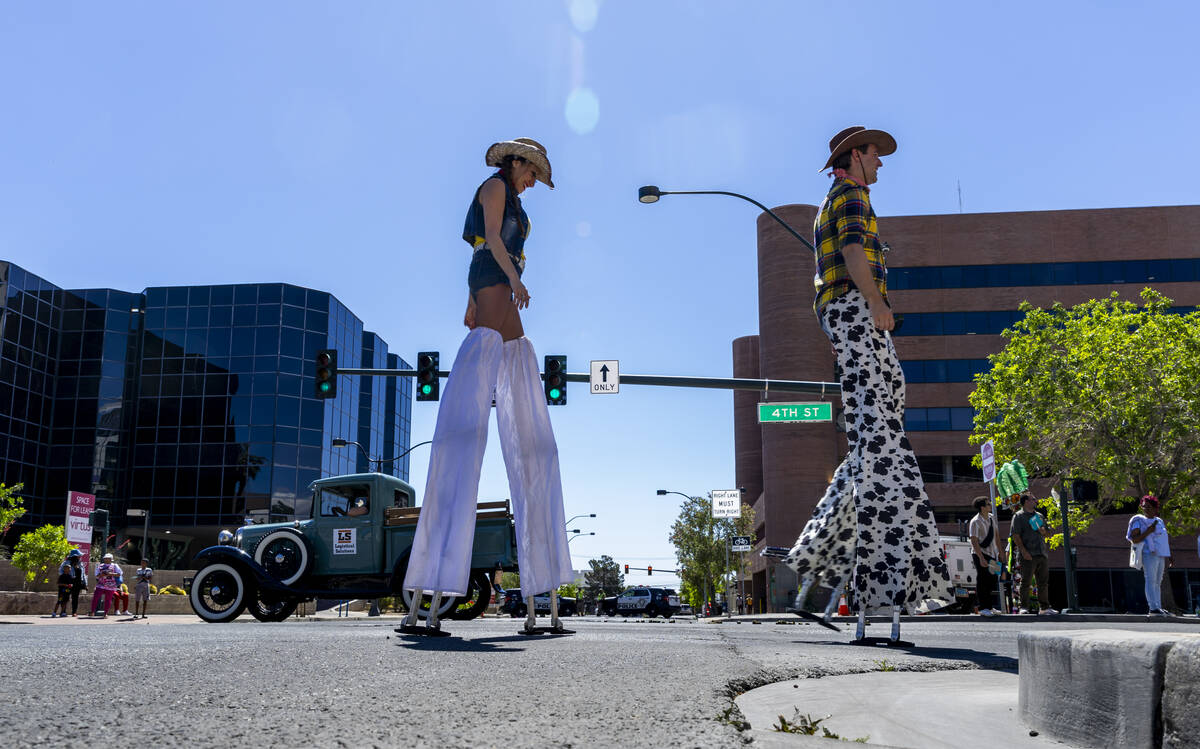 Stilt walkers wander along the route during the Helldorado Parade moving up 4th Street on Satur ...