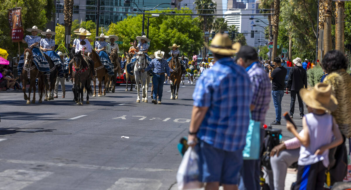 Members of the Escaramuza Charra of Nevada make their way on horseback along the route during t ...