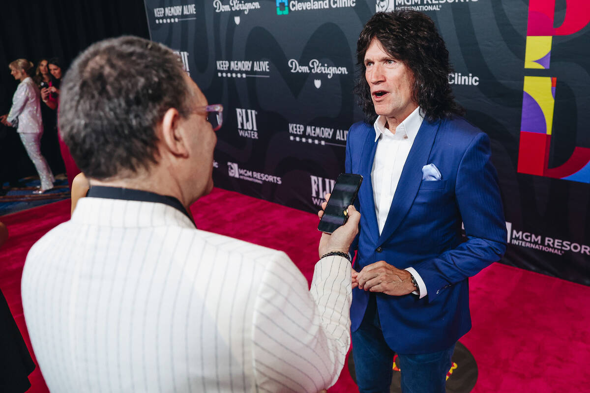 Musician Tommy Thayer speaks to reporters on the red carpet at the 27th annual Power of Love ga ...