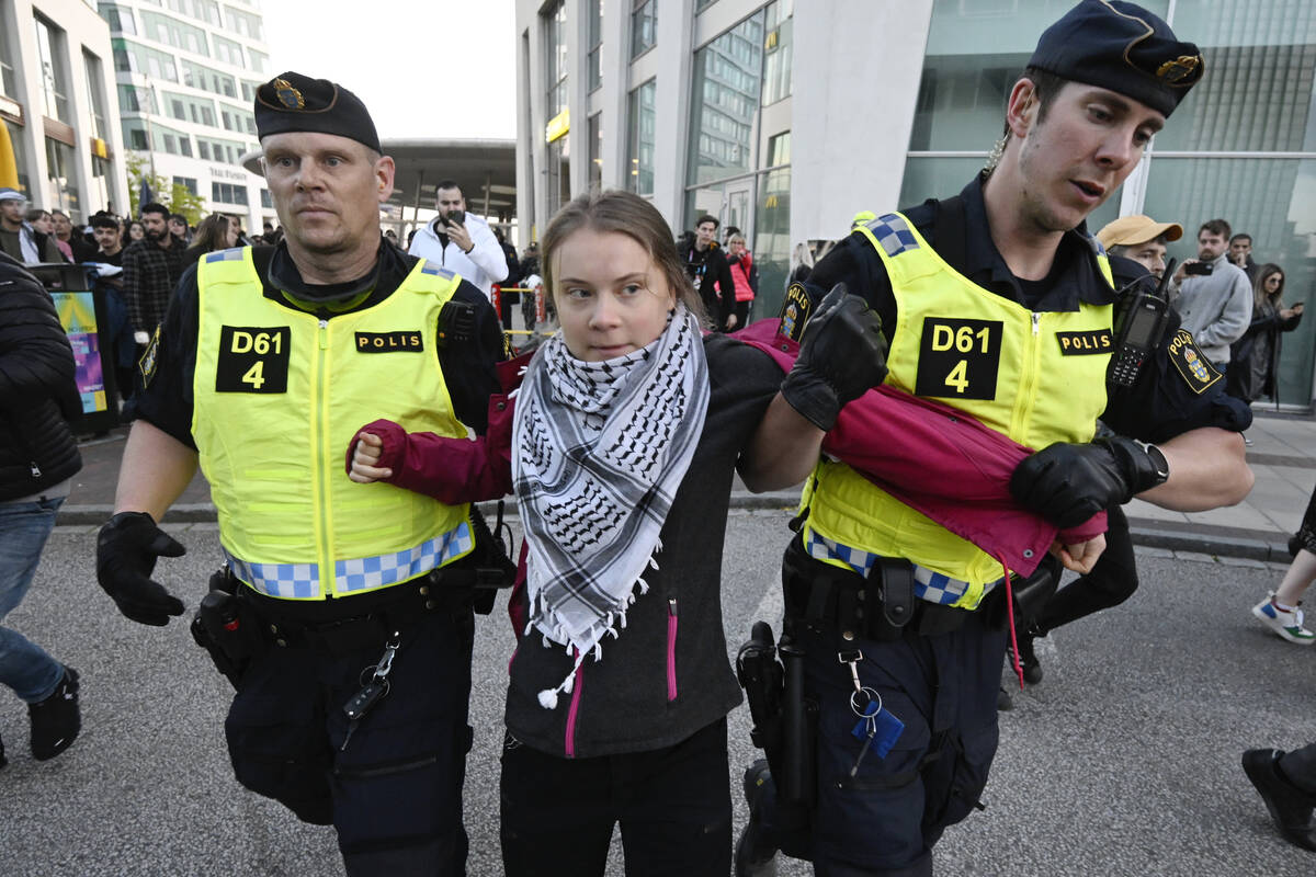 Climate activist Greta Thunberg is removed by police during a protest rally outside Malmo Arena ...