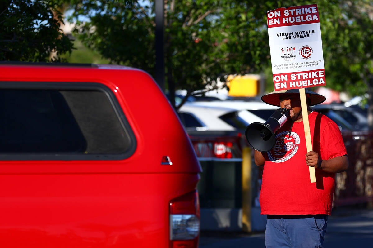 A demonstrator asks vehicles to not cross the picket line on the second day of a strike outside ...