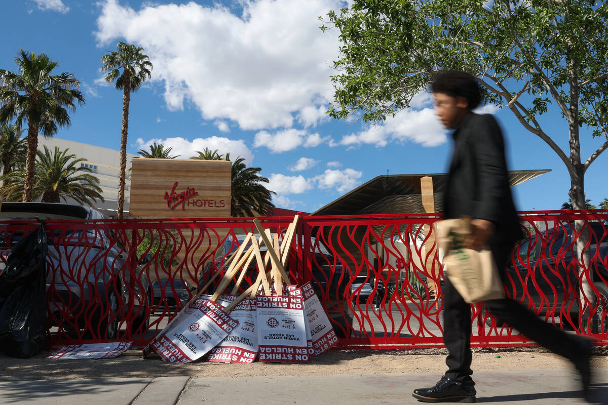 A pedestrian passes Virgin Hotels Las Vegas on the second day of a strike outside the hotel-cas ...