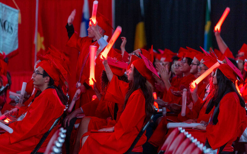 Graduates applaud by waving light sticks during UNLV spring graduation commencement exercises a ...