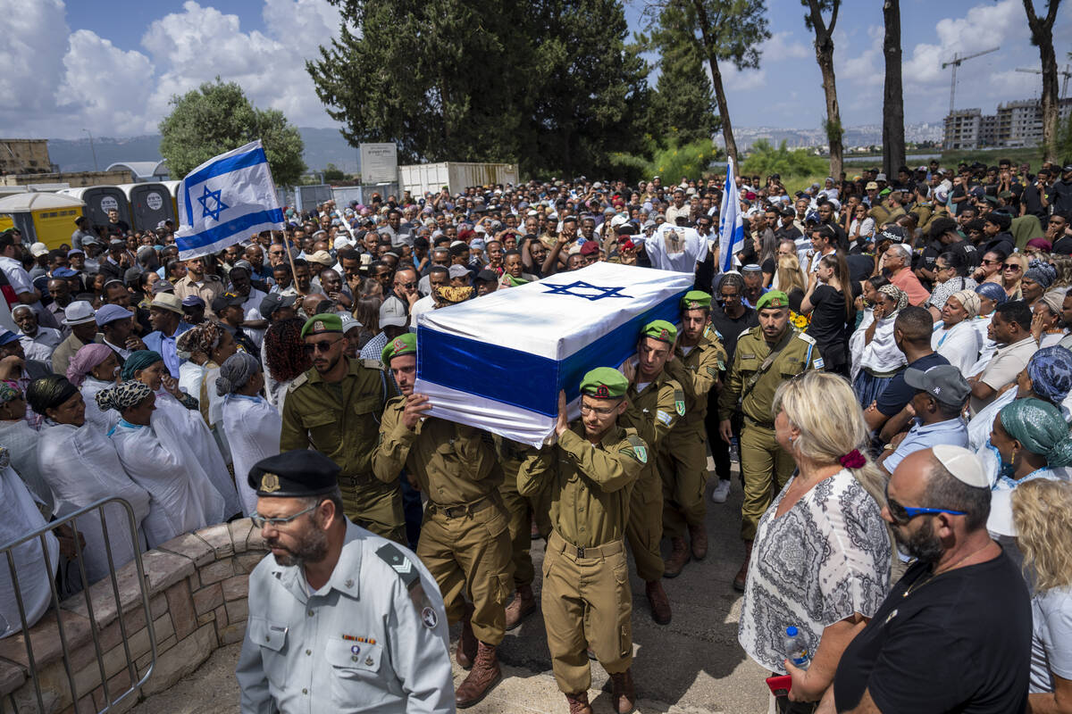 Israeli soldiers carry the casket of Sergeant Yosef Dassa during his funeral in Kiryat Ata, Isr ...