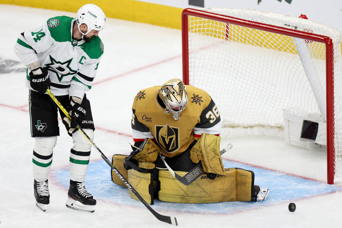 Golden Knights goaltender Logan Thompson (36) saves the puck against Stars left wing Jamie Benn ...