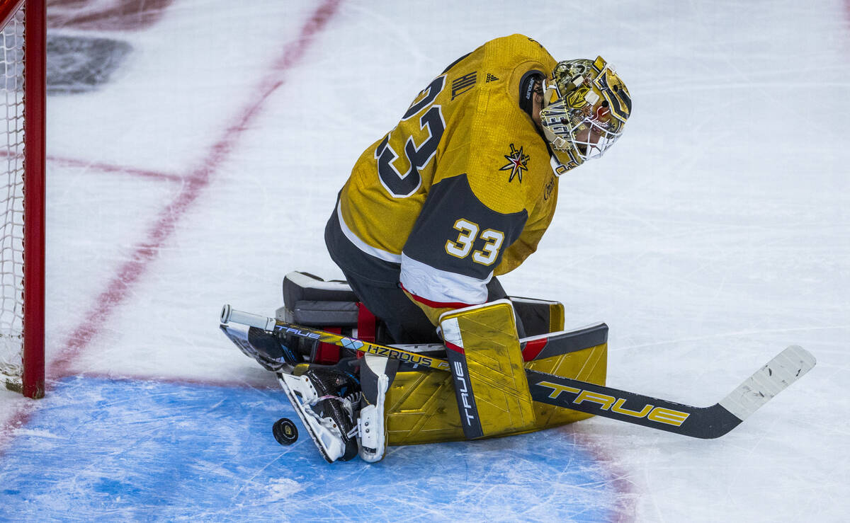 Golden Knights goaltender Adin Hill (33) deflects a shot off his skate against the Dallas Stars ...