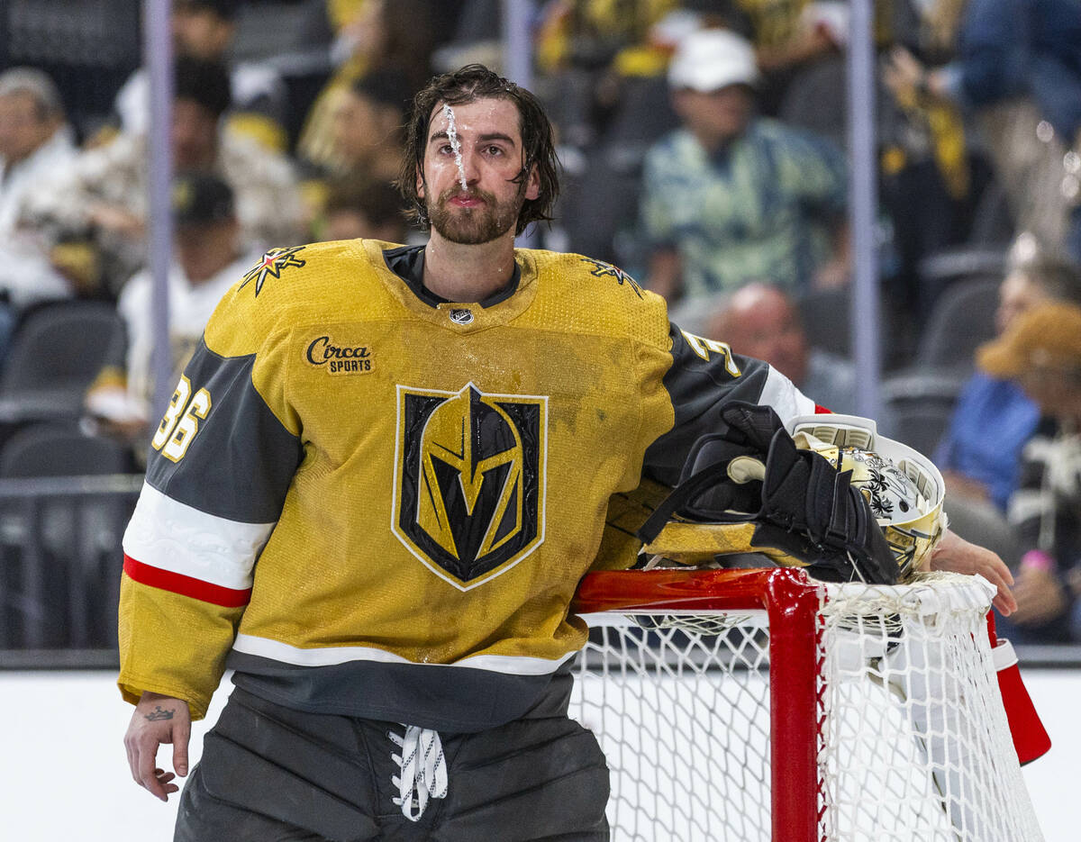 Golden Knights goaltender Logan Thompson (36) spits out some water during a break again the Dal ...