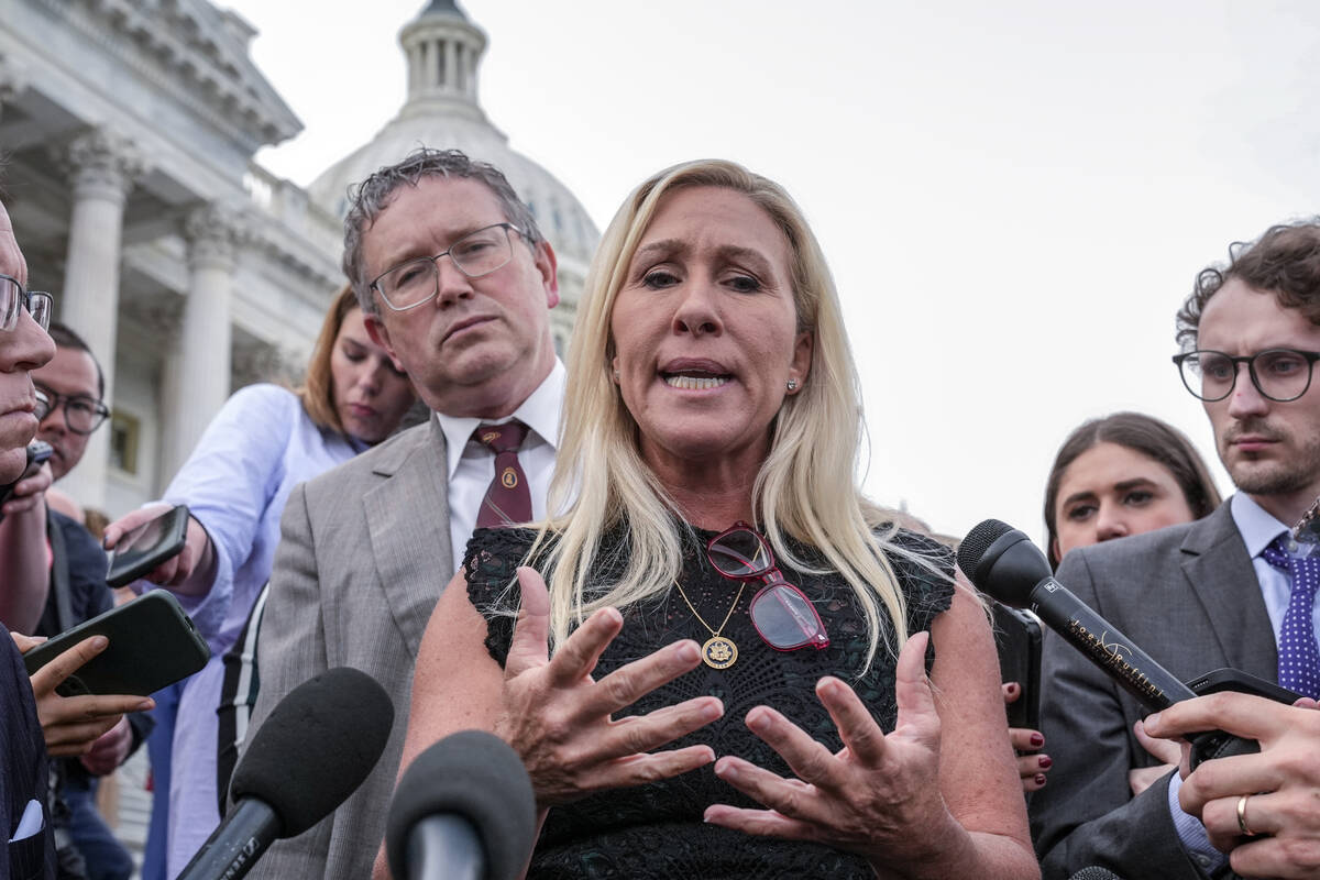 Rep. Marjorie Taylor Greene, R-Ga., joined by Rep. Thomas Massie, R-Ky., speaks to reporters af ...